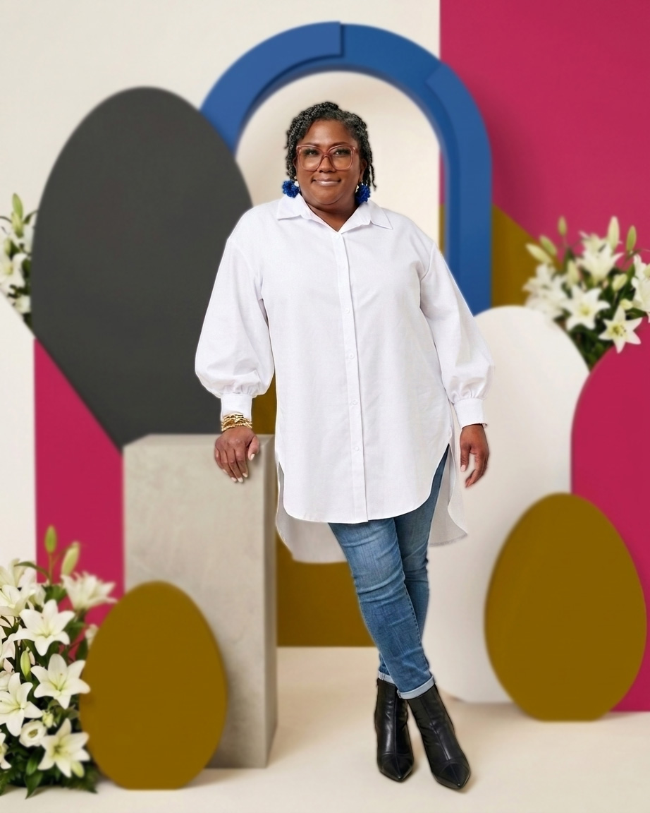 Torrie Powell, LCSW, LCAS — founder of Emerging Hearts Mental Wellness Center, standing confidently in a white shirt against a colorful studio backdrop